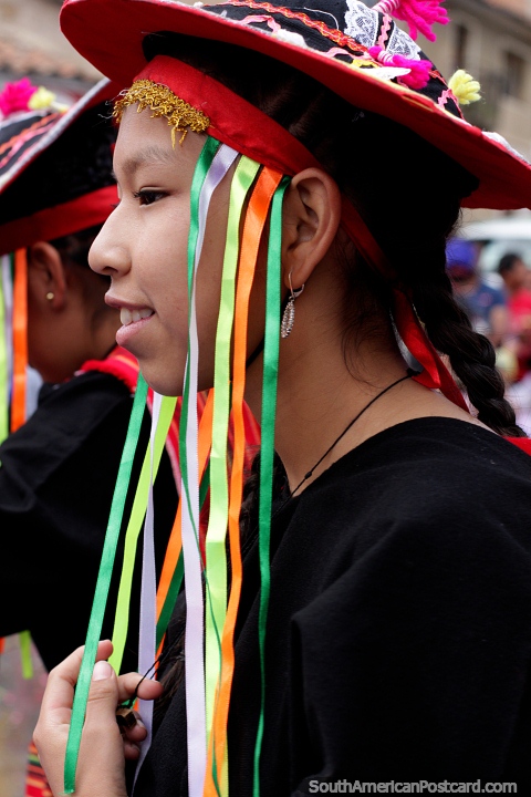 Young woman with an interesting hat looks nice at the carnival in Sucre. (480x720px). Bolivia, South America.