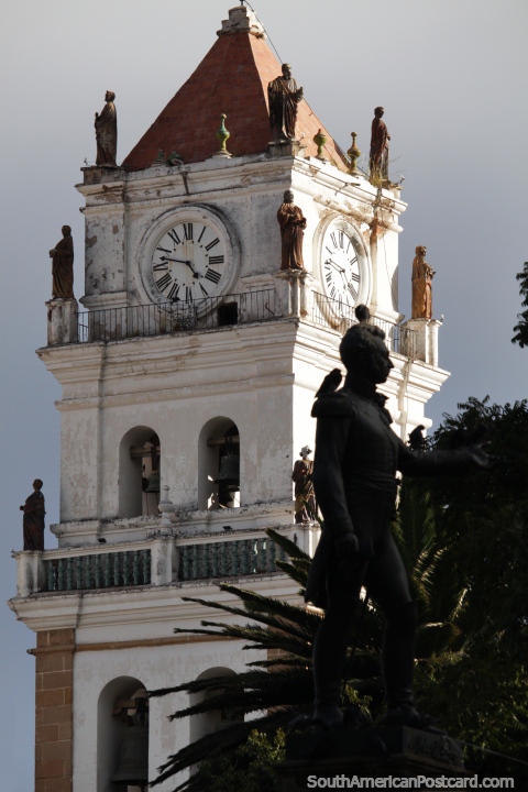 Cathedral tower with many small gold figures and the main statue from the center of the plaza in Sucre. (480x720px). Bolivia, South America.