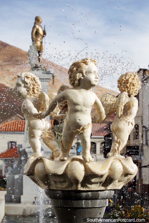 Fountain with 3 little white angels dance in the water spray in central Potosi. (480x720px). Bolivia, South America.