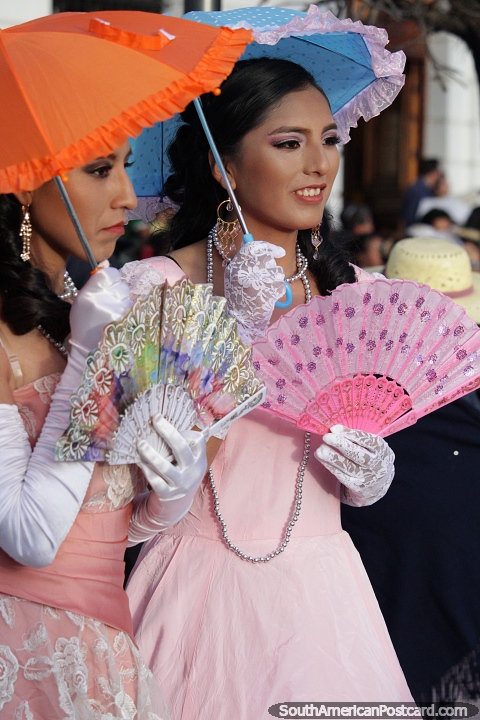 The duchess of Potosi looks wonderful in her pink dress and blue umbrella, a pink fan too. (480x720px). Bolivia, South America.