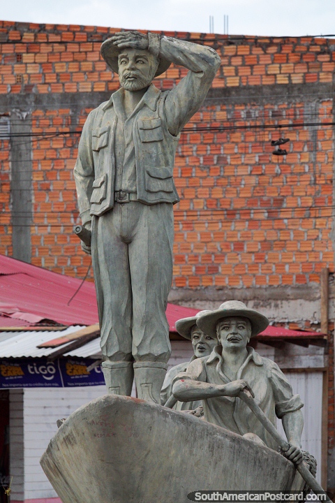 2 men rowing a boat, another man stands on the bow, one of several monuments in Riberalta. (480x720px). Bolivia, South America.