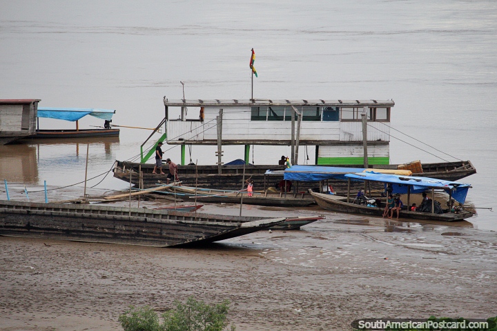 Bote de madera de 2 niveles y otros botes alrededor de las arenas húmedas en el puerto de Riberalta. (720x480px). Bolivia, Sudamerica.