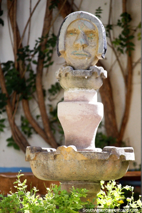 Water feature featuring an indigenous face, gardens at a front patio in Tarabuco. (480x720px). Bolivia, South America.