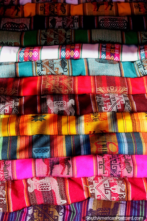 A range of colored shawls to carry goods or your baby around in, Tarabuco market. (480x720px). Bolivia, South America.