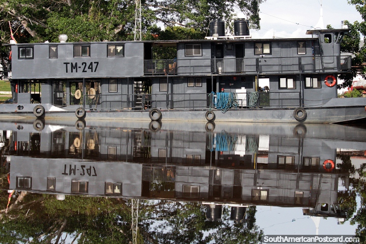 Symmetrical reflections of a large grey boat on the silky smooth waters of the Mamore River, Trinidad. (720x480px). Bolivia, South America.
