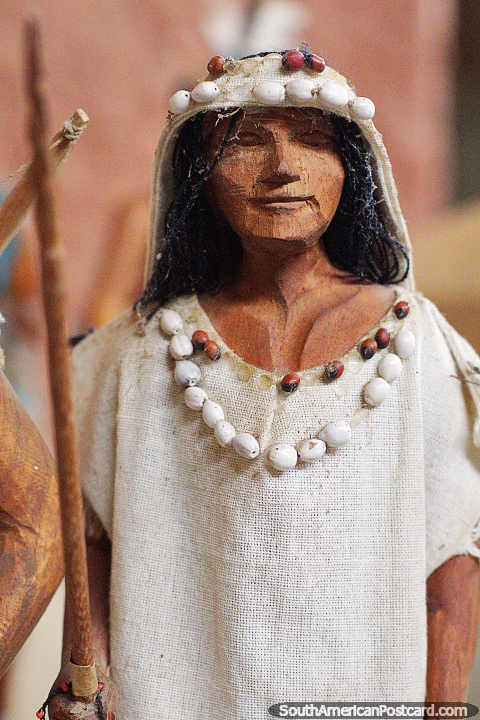 Woman wearing cotton head-wear and dress with a necklace of shells, figure at the Kenneth Lee Museum, Trinidad. (480x720px). Bolivia, South America.