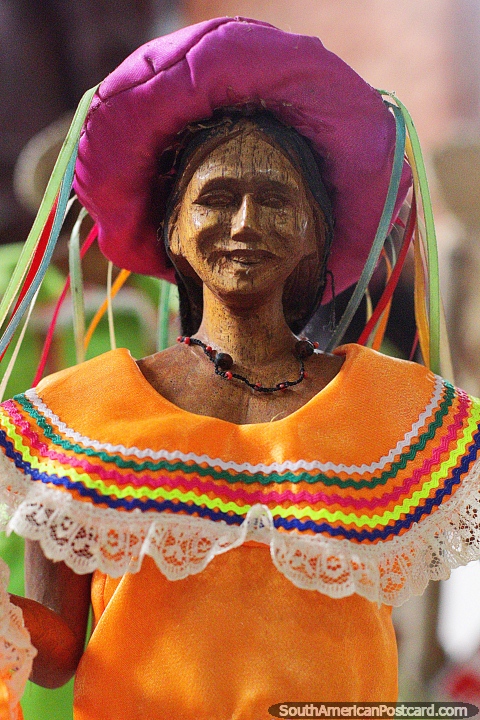 Monchi (San Joaquin), woman with orange dress and a purple hat, cultural figure at the Kenneth Lee Museum, Trinidad. (480x720px). Bolivia, South America.