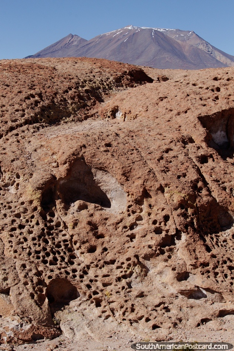 Porous rock, if the holes are connected then water can flow through it, a distant mountain in Uyuni. (480x720px). Bolivia, South America.