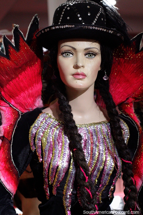 Morena costume from 1980, woman in a black hat, she has pink wings, Anthropological Museum, Oruro. (480x720px). Bolivia, South America.
