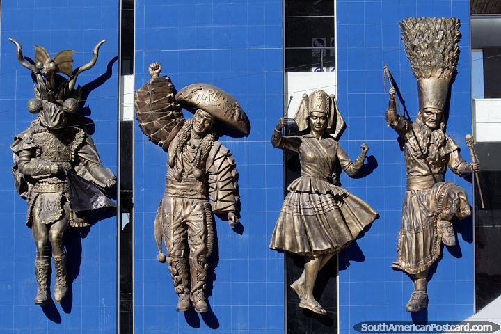 4 figures in traditional costumes and masks, amazing bronze work on a building side in Oruro, carnival. (720x480px). Bolivia, South America.