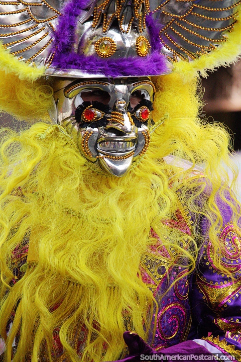 Amazing masks at El Gran Poder parade in La Paz, yellow and purple outfit. (480x720px). Bolivia, South America.