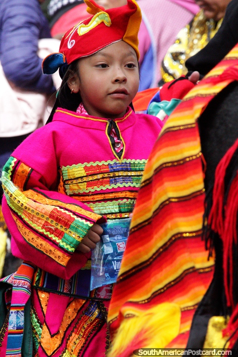 Child dressed in an amazing pink technicolor outfit marches in the El Gran Poder parade in La Paz. (480x720px). Bolivia, South America.