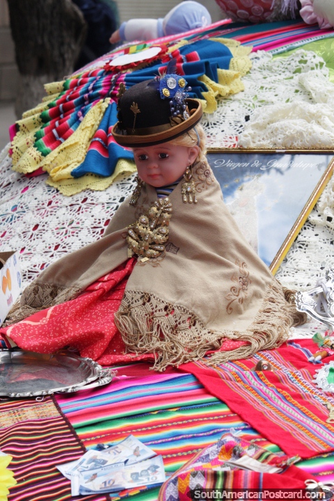 Hat lady doll sits upon a car bonnet, the tradition of the festival of the Virgin of Guadalupe in Sucre. (480x720px). Bolivia, South America.