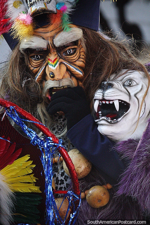 Masked man with a white saber-toothed tiger, traditional costume and mask at El Gran Poder parade in Sucre. (480x720px). Bolivia, South America.
