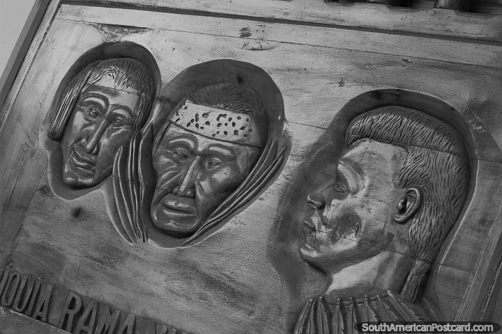 Sculptured wood carvings with 3 faces on the facade of a hotel and restaurant in San Jose de Chiquitos. (720x480px). Bolivia, South America.