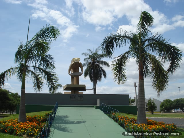 Monument to the miners with orange and yellow flower gardens in Boa Vista. (640x480px). Brazil, South America.