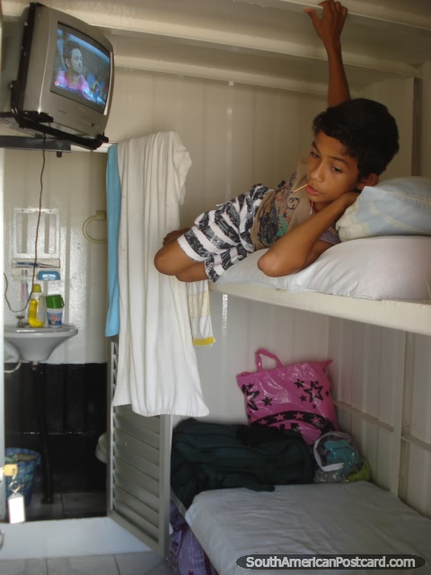 2 bunks, bathroom and tv in the private cabins on the Amazon river passenger boats. (480x640px). Brazil, South America.