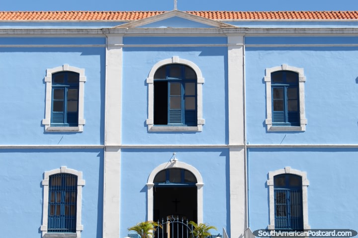 The bright blue facade and tiled roof of the college in Santarem - Colegio Santa Clara. (720x480px). Brazil, South America.