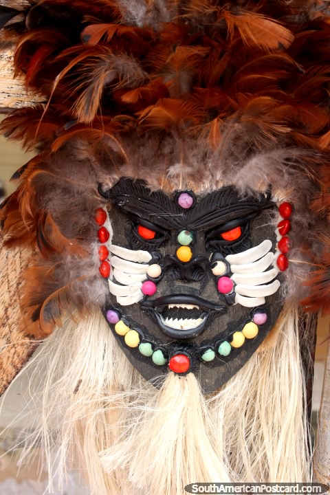 An amazing wooden mask with colored beads and feathers for sale at an art shop in Alter do Chao near Santarem. (480x720px). Brazil, South America.