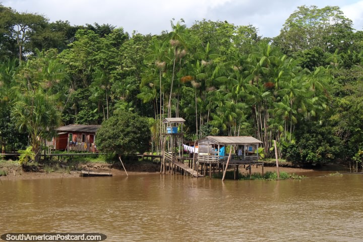 A house with a water tower and river shelter on the river north of Breves in the Amazon. (720x480px). Brazil, South America.