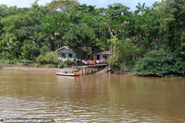 Boat arrives to pick up a man from his house in the Amazon jungle north of Breves. (720x480px). Brazil, South America.