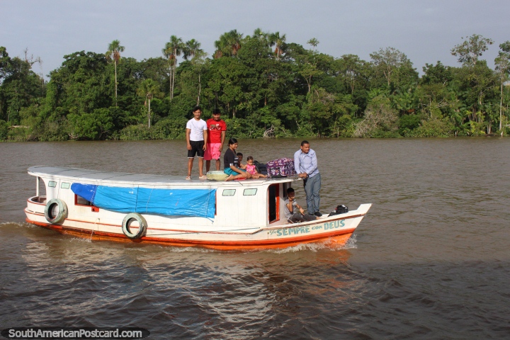 A family pulls up beside the ferry to join the final hours of the trip to Macapa. (720x480px). Brazil, South America.