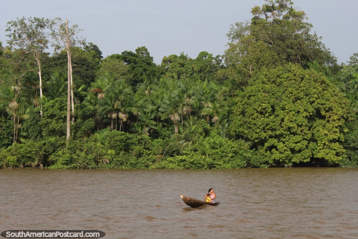 Woman and child in a canoe on a river south of Macapa. (720x480px). Brazil, South America.