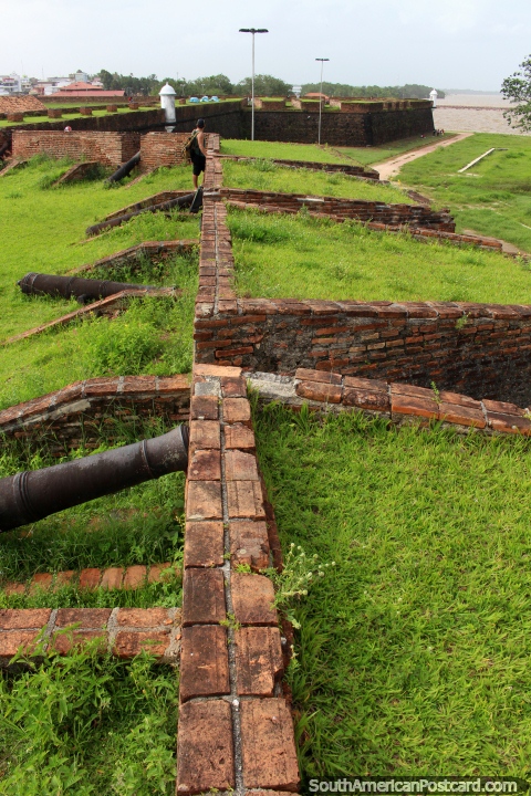 Olhar ao longo de paredes de tijolos com vário canhão no forte em Macapa. (480x720px). Brasil, América do Sul.