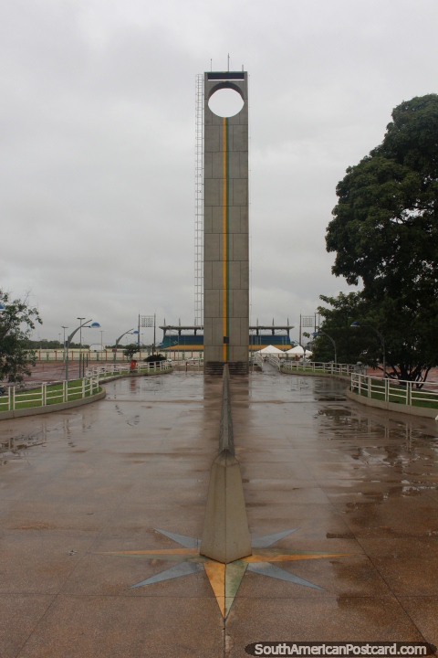 The equator monument and line at the Equinocio (Marco Zero) in Macapa,  football stadium behind has the middle line on the equator also. (480x720px). Brazil, South America.