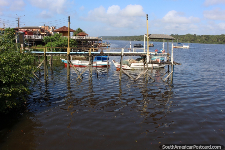Boats in the Oyapock River, some moored, some traveling, in Oiapoque. (720x480px). Brazil, South America.
