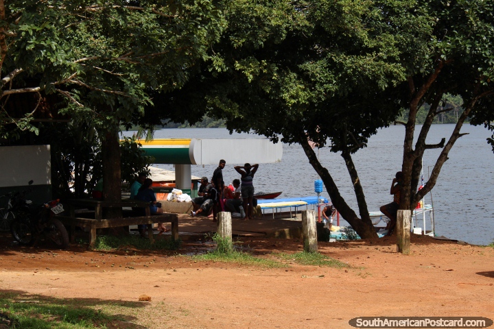 People under trees beside the Oyapock River in Oiapoque. (720x480px). Brazil, South America.