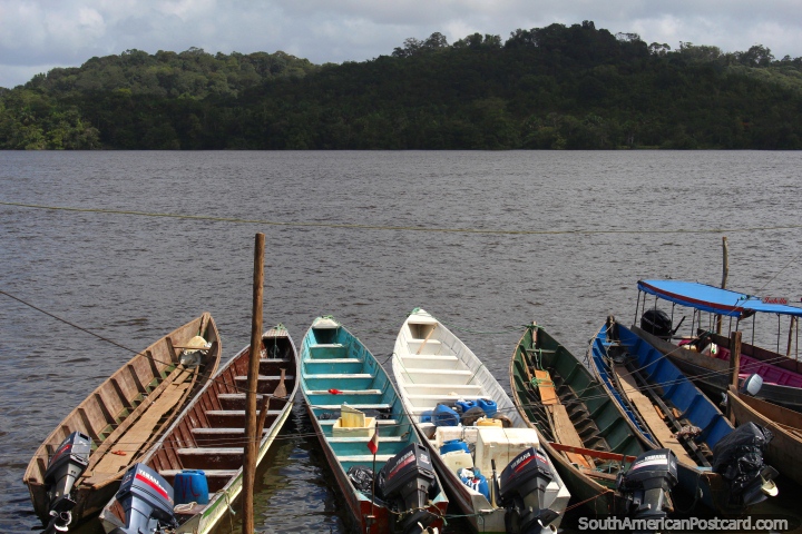 Moored boats in Oiapoque point towards the riverbanks of French Guiana. (720x480px). Brazil, South America.