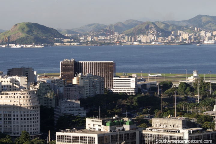 Plane lands at the city airport, a beautiful harbor and backdrop in Rio de Janeiro. (720x480px). Brazil, South America.