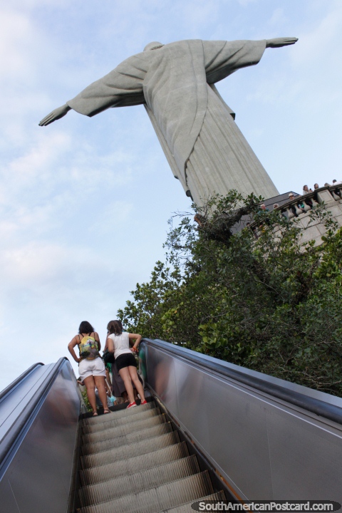 Jesus attempts to fly, others just take the escalator, Corcovado Mountain, Rio de Janeiro. (480x720px). Brazil, South America.