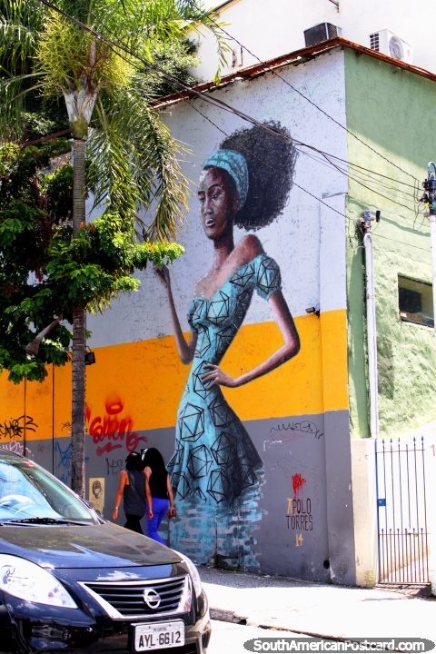 Tall mural of a woman towers over 2 real women around Vila Madalena, Sao Paulo. (480x720px). Brazil, South America.