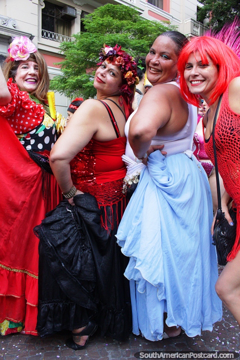 4 women in colorful fancy dress pose for a picture at carnival activities in Sao Paulo. (480x720px). Brazil, South America.