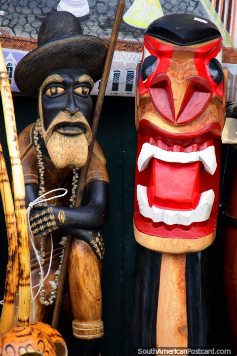 An old man and a creature with tongue, wooden carvings, crafts in Salvador. (480x720px). Brazil, South America.