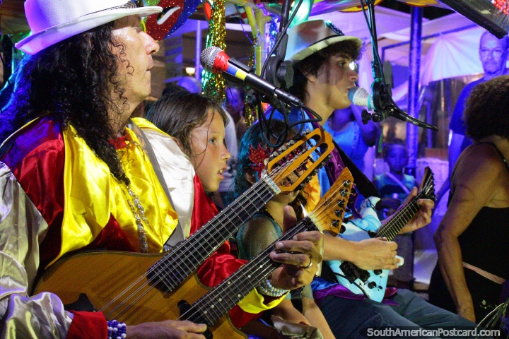 A family play music as they travel around in a very small vehicle at Salvador carnival. (720x480px). Brazil, South America.