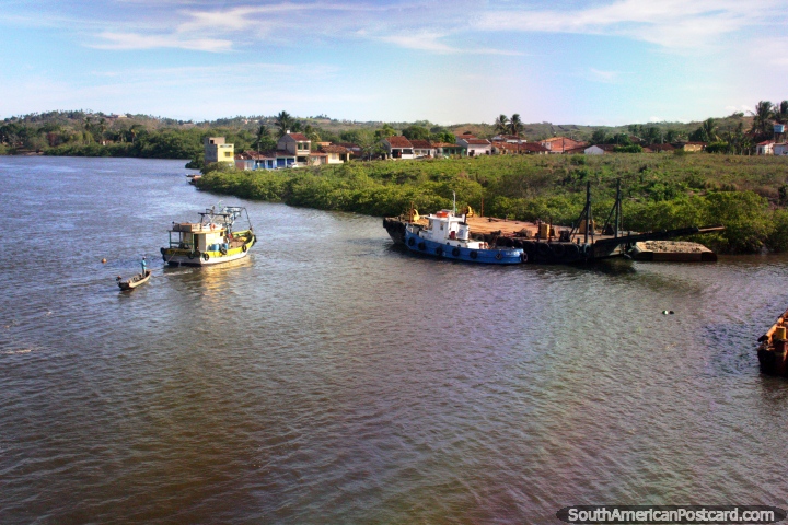 Barge, tugboats and houses at the river crossing between Aracaju and Penedo. (720x480px). Brazil, South America.