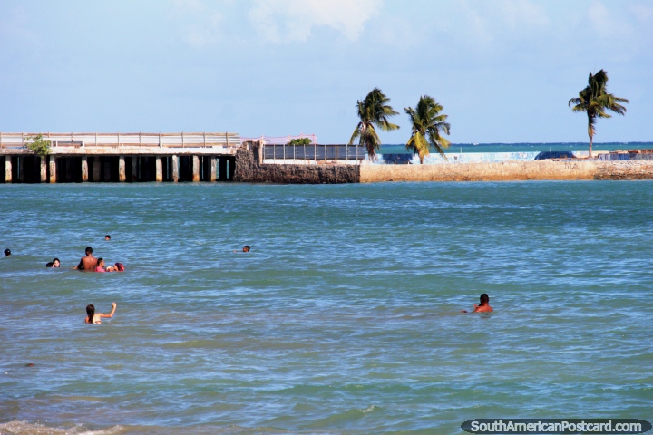People swimming at the less crowded end of Pajucara Beach in Maceio. (720x480px). Brazil, South America.