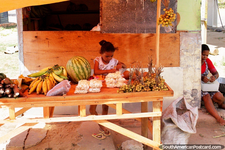 Young girl and her mother prepare their produce for sale from the roadside in Japaratinga. (720x480px). Brazil, South America.