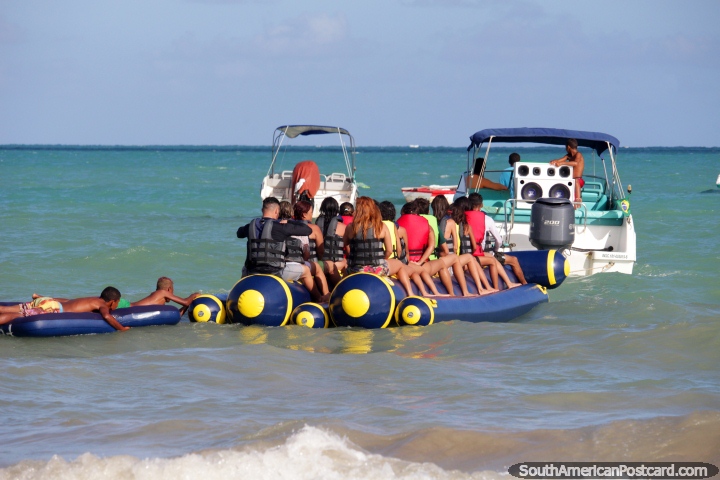 Banana boat ready to ride, has 2 local extras hanging on the back, Maragogi. (720x480px). Brazil, South America.