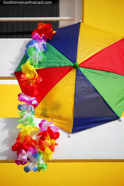 Colorful umbrella and carnival decorations outside a house in Maragogi. (480x720px). Brazil, South America.