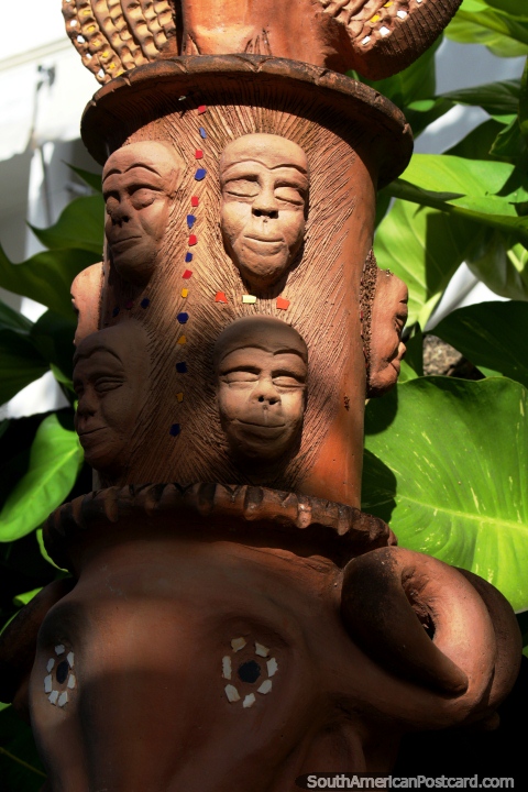 Monkey faces carved out of wood, an art piece in Olinda. (480x720px). Brazil, South America.