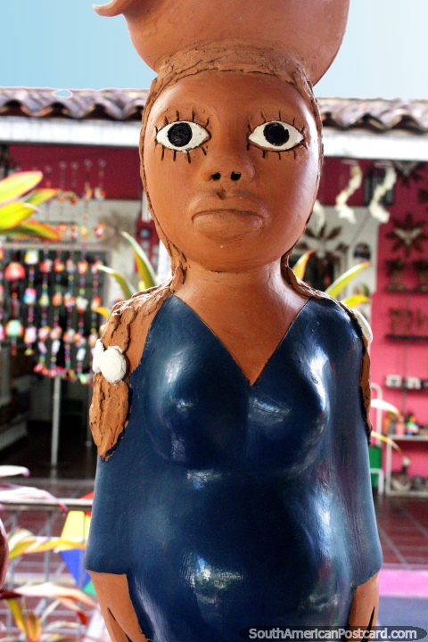 Mujer en azul con una olla en su cabeza, de una tienda de arte de Olinda. (480x720px). Brasil, Sudamerica.