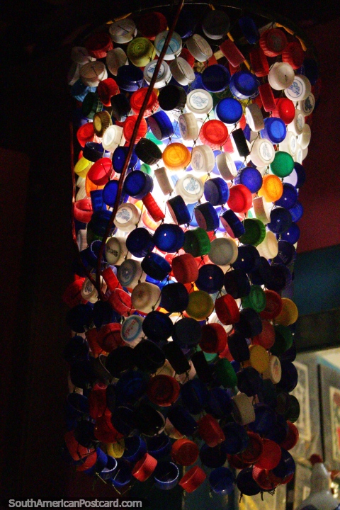 A light made out of colored bottle-tops in the main street in Pipa. (480x720px). Brazil, South America.