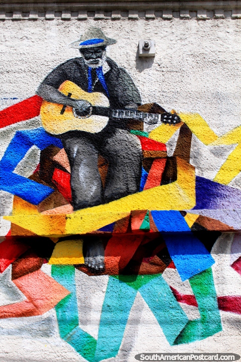Man plays an acoustic guitar, a fantastic mural with nice colors in Natal. (480x720px). Brazil, South America.
