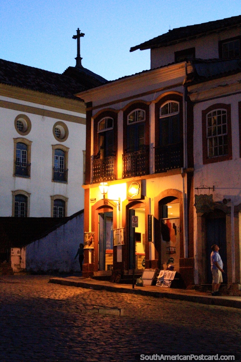 The golden lights and shapes of the buildings at dusk in Ouro Preto. (480x720px). Brazil, South America.