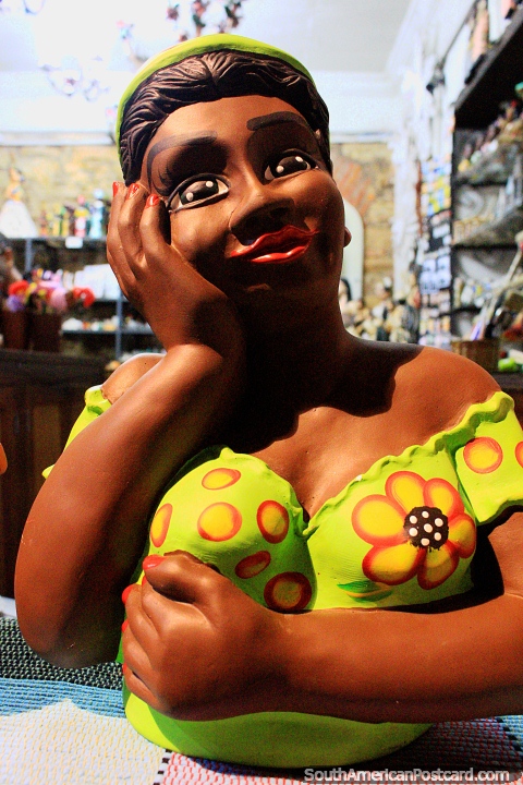 Woman figurine in yellow dress at an art shop in Ouro Preto. (480x720px). Brazil, South America.