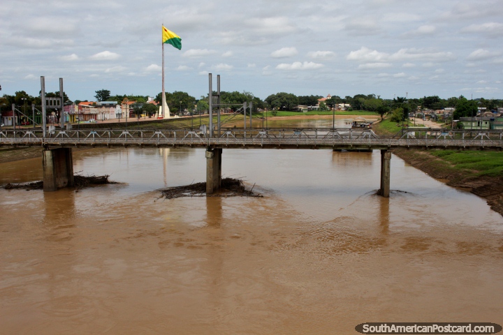 Acre River with one of 3 bridge crossings in central Rio Branco, yellow and green flag flying. (720x480px). Brazil, South America.